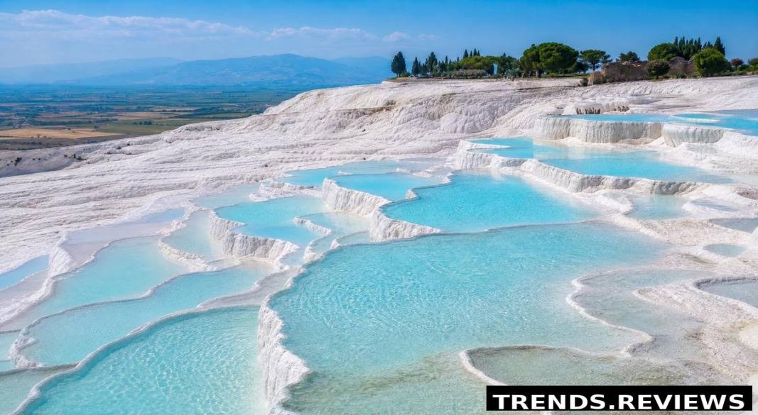 Pamukkale white travertine terraces and thermal pools under the blue sky in Turkey.